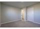 Spacious carpeted bedroom with multiple doors at 5341 Granby St, Denver, CO 80239