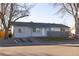 Inviting single-story home with a spacious driveway, manicured lawn, and welcoming front entrance at 5341 Granby St, Denver, CO 80239