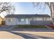 Charming single-story home with a well-maintained lawn, updated facade, and inviting front entrance at 5341 Granby St, Denver, CO 80239