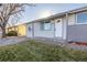 Updated front entrance with white door and gray siding at 5341 Granby St, Denver, CO 80239