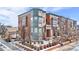 Three-story brick townhome with a gray accent at 2946 Central Park Blvd, Denver, CO 80238