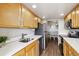 Well-lit kitchen offers stainless steel appliances, ample counter space, and stylish wood flooring at 1250 N Humboldt St # 1504, Denver, CO 80218