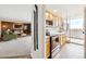 Bright kitchen features light wood cabinets, stainless appliances, and a doorway to the living area at 1250 N Humboldt St # 1504, Denver, CO 80218