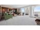 Bright living room with a comfortable seating area and large windows leading to a furnished balcony at 1250 N Humboldt St # 1504, Denver, CO 80218