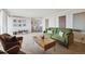 Inviting living room featuring cozy seating, modern artwork, and an open layout leading to the dining area at 1250 N Humboldt St # 1504, Denver, CO 80218