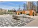 Spacious outdoor patio with modern seating, decorative art, and vibrant landscaping at 1250 N Humboldt St # 1504, Denver, CO 80218