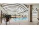 Bright indoor pool area with comfortable lounge furniture and lush greenery at 1250 N Humboldt St # 1504, Denver, CO 80218