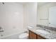 Bathroom features a tub, granite vanity, and modern fixtures at 2066 S Holly St # 3, Denver, CO 80222