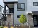 Attractive townhome showcasing modern design, stone accents, and a cozy balcony at 2066 S Holly St # 3, Denver, CO 80222