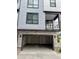 Two car garage with white doors and stone facade at 2066 S Holly St # 3, Denver, CO 80222