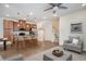 Open-concept living area with kitchen island, cozy seating, and staircase access at 2066 S Holly St # 3, Denver, CO 80222