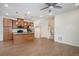 Open-concept living area with kitchen island, cozy seating, and staircase access at 2066 S Holly St # 3, Denver, CO 80222