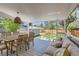 Spacious covered patio with outdoor dining and lounge area with backyard view at 3975 S Logan St, Englewood, CO 80113