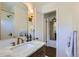 Elegant bathroom featuring marble countertops, brass fixtures, and a well-lit vanity at 3975 S Logan St, Englewood, CO 80113