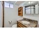 Bathroom features a granite vanity and a shower with tile surround at 3975 S Logan St, Englewood, CO 80113