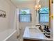 Stylish bathroom with marble countertops, a tub, and modern brass fixtures at 3975 S Logan St, Englewood, CO 80113