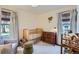 Cozy Bedroom with a wooden crib, dresser, and soft natural light at 3975 S Logan St, Englewood, CO 80113