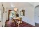 Bright dining room featuring a rustic table, wooden chairs, and a red striped rug at 3975 S Logan St, Englewood, CO 80113
