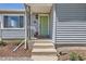 Inviting front entrance showcases a green door and manicured plants at 3975 S Logan St, Englewood, CO 80113