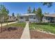 Beautifully landscaped front yard with a walkway leading to the inviting entrance of this lovely home at 3975 S Logan St, Englewood, CO 80113