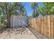 Detached garage with a concrete driveway and a wood fence at 3975 S Logan St, Englewood, CO 80113