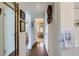 Bright hallway featuring hardwood floors, white walls, and access to other rooms at 3975 S Logan St, Englewood, CO 80113