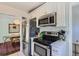 Efficient kitchen with stainless steel appliances and white countertops open to the dining room at 3975 S Logan St, Englewood, CO 80113