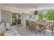 Covered patio with a dining table and comfortable sofa, perfect for entertaining at 3975 S Logan St, Englewood, CO 80113