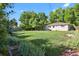 Large grassy backyard with mature trees and home view at 6642 S Bridger Ct, Centennial, CO 80121