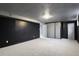 Finished basement room with dark walls and carpet flooring at 6642 S Bridger Ct, Centennial, CO 80121