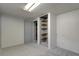 Unfinished basement room with built-in shelving and grey walls at 6642 S Bridger Ct, Centennial, CO 80121