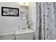 Clean bathroom with white vanity and floral shower curtain at 6642 S Bridger Ct, Centennial, CO 80121