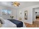 Bedroom with hardwood floors, en-suite bathroom, and ceiling fan at 6642 S Bridger Ct, Centennial, CO 80121