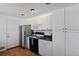 Modern kitchen with white cabinets, black appliances, and good storage at 6642 S Bridger Ct, Centennial, CO 80121