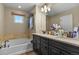 Luxurious bathroom with double vanity, soaking tub, and ample storage space at 7976 E 53Rd Dr, Denver, CO 80238