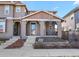 Inviting home exterior featuring a covered porch and attractive landscaping details at 7976 E 53Rd Dr, Denver, CO 80238