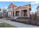 Charming two-story home with a covered front porch and well-manicured landscaping at 7976 E 53Rd Dr, Denver, CO 80238