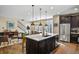 Open-concept kitchen with an island, stainless steel appliances, and hardwood floors at 7976 E 53Rd Dr, Denver, CO 80238