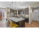Spacious kitchen with a large center island, stainless steel appliances, and dark cabinetry at 7976 E 53Rd Dr, Denver, CO 80238