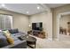 Finished basement living room, complete with TV, cabinets, hardwood flooring, and comfortable seating at 7976 E 53Rd Dr, Denver, CO 80238