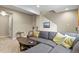 Basement living room with a comfortable gray sectional sofa and stylish decor at 7976 E 53Rd Dr, Denver, CO 80238
