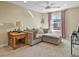Comfortable living room featuring a cozy sectional sofa, stylish curtains, and a ceiling fan at 7976 E 53Rd Dr, Denver, CO 80238