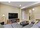 Finished basement living room with a sectional sofa, tv and hardwood cabinets at 7976 E 53Rd Dr, Denver, CO 80238