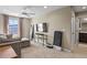 Living room showcasing a large window, TV, ladder, and a glimpse into the bathroom at 7976 E 53Rd Dr, Denver, CO 80238