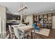 Open concept living area featuring a gourmet kitchen, dining space, and large shelving unit at 7976 E 53Rd Dr, Denver, CO 80238