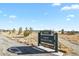 Scenic park entrance with lush green grass, mature trees, and clear blue skies at 7976 E 53Rd Dr, Denver, CO 80238