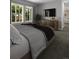 Serene bedroom with a queen bed, large windows, and contemporary decor for a peaceful retreat at 17055 W 92Nd Loop, Arvada, CO 80007