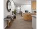 Hallway featuring wood floors, a marble table, and a view of the stairs and kitchen at 17055 W 92Nd Loop, Arvada, CO 80007