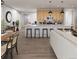 Open kitchen with light wood cabinets, stainless steel appliances, and island with seating, great for entertaining at 17055 W 92Nd Loop, Arvada, CO 80007