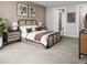 Bright main bedroom with patterned headboard, soft carpet, and neutral tones offering a serene escape at 17055 W 92Nd Loop, Arvada, CO 80007